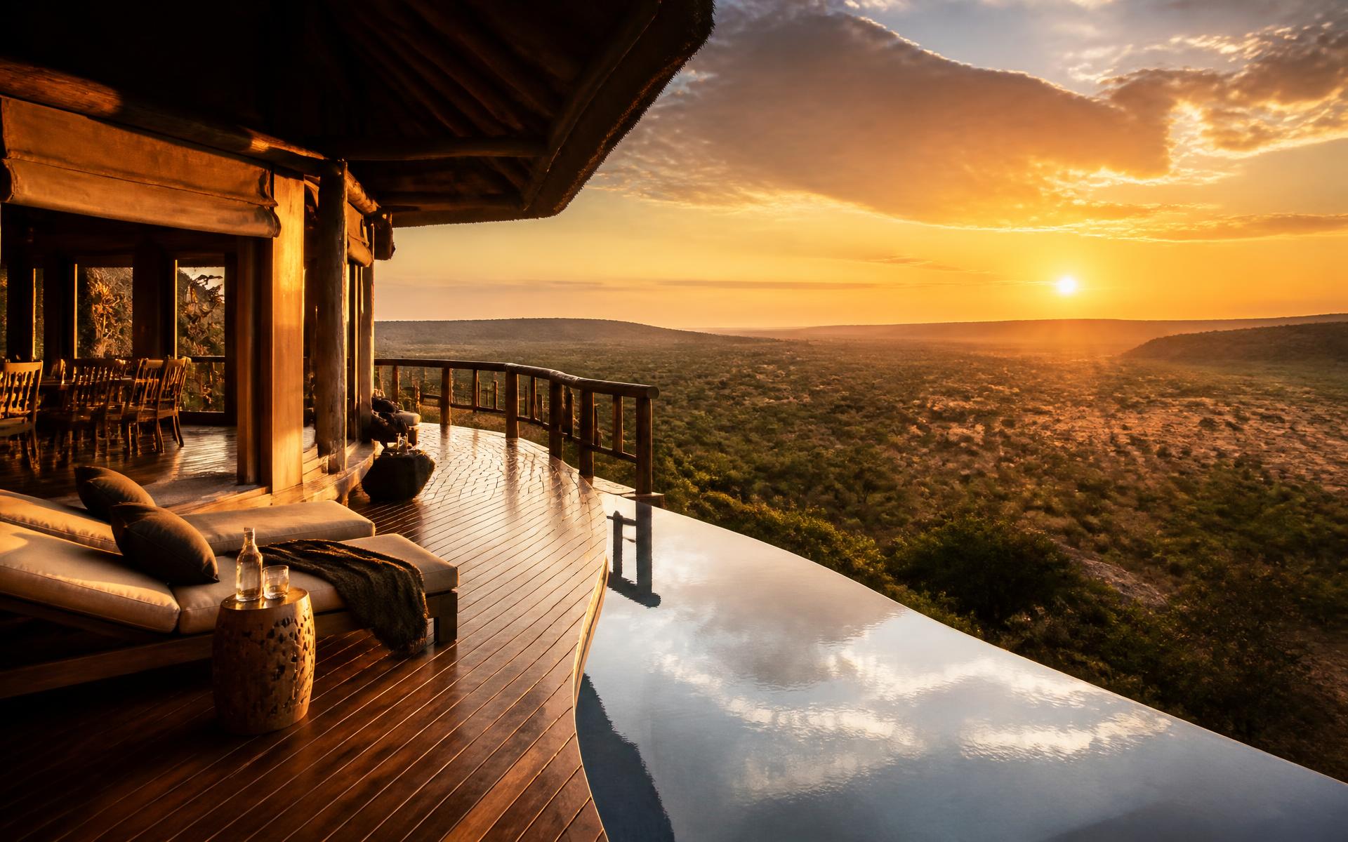 Luxury safari lodge deck overlooking the African wilderness at sunrise